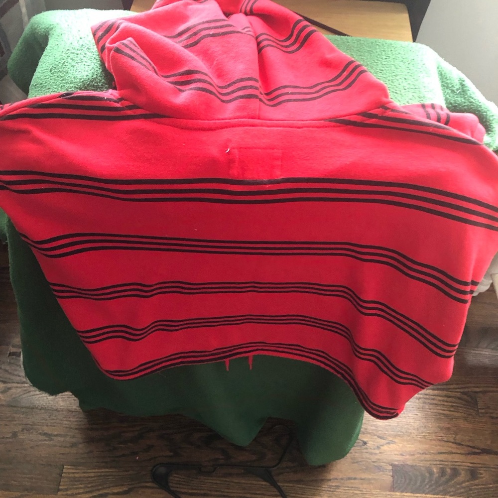 Red with black stripes half sweater hoodie with long sleeves and red drawstring.